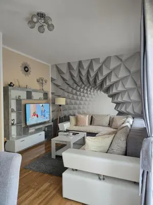 a living room with a couch and a tv at Apartman Tina in Soko Banja