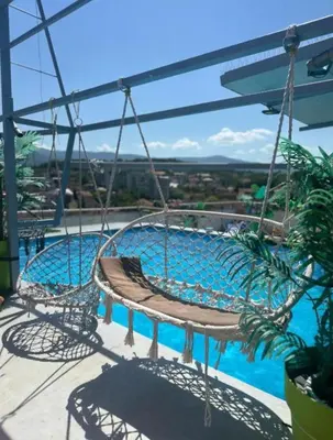 a swing over a swimming pool on a balcony at Elegant Lux in Vrnjci