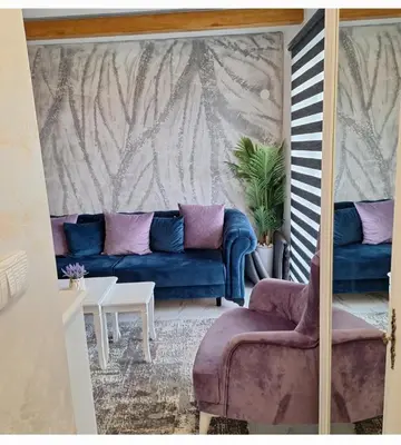 a living room with a blue couch and a table at Elegant Lux in Vrnjci
