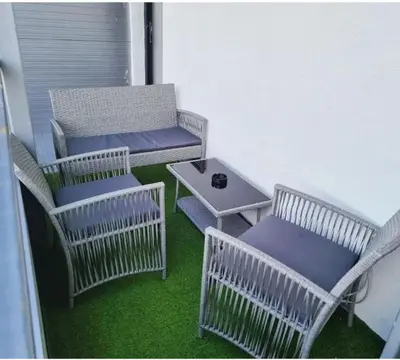 a balcony with three chairs and a table and a bench at Elegant Lux in Vrnjci