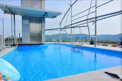 a large swimming pool with chairs on a building at Elegant Lux in Vrnjci