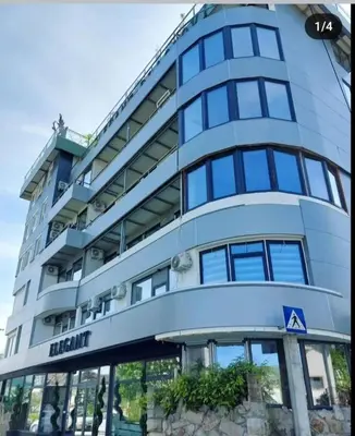 a tall blue building with a sign on it at Elegant Lux in Vrnjci