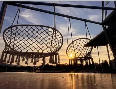 two metal chairs with the sunset in the background at Elegant Lux in Vrnjci