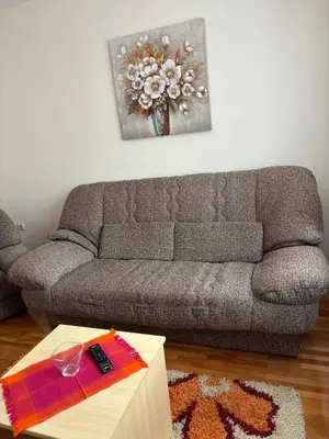 a living room with a couch and a table at Apartman LENKA in Pirot
