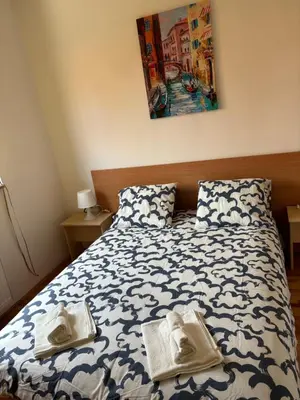 a bedroom with a bed with two towels on it at Apartman LENKA in Pirot