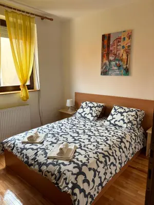 a bedroom with a bed with two towels on it at Apartman LENKA in Pirot