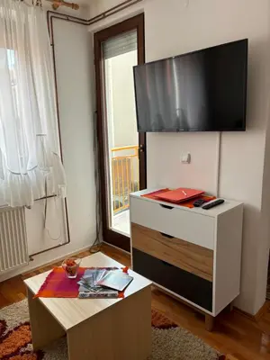 a living room with a flat screen tv on a wall at Apartman LENKA in Pirot