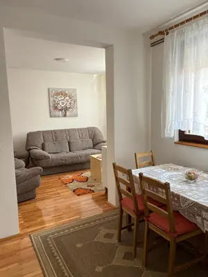 a living room with a table and a couch at Apartman LENKA in Pirot