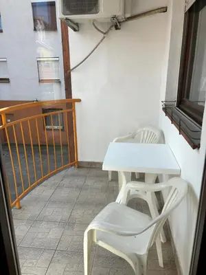 a white table and two chairs on a balcony at Apartman LENKA in Pirot
