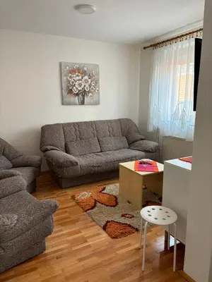 a living room with a couch and a table at Apartman LENKA in Pirot