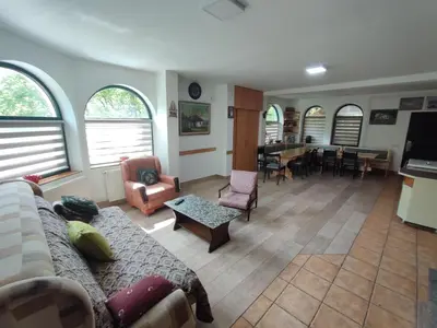 a living room with a couch and a table at Kuca za odmor Lisine in Despotovac