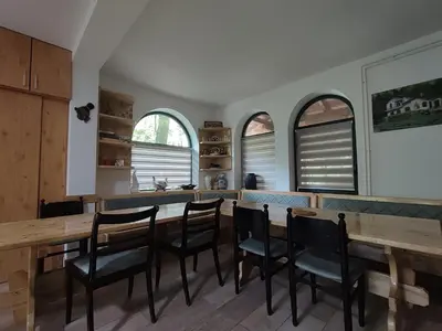 a kitchen with a long wooden table and chairs at Kuca za odmor Lisine in Despotovac