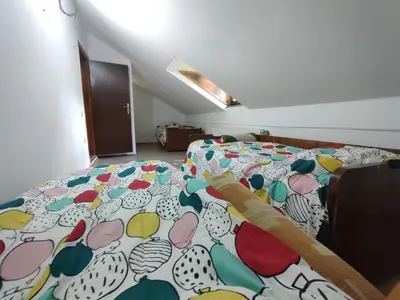 a bedroom with a bed with a colorful comforter at Kuca za odmor Lisine in Despotovac