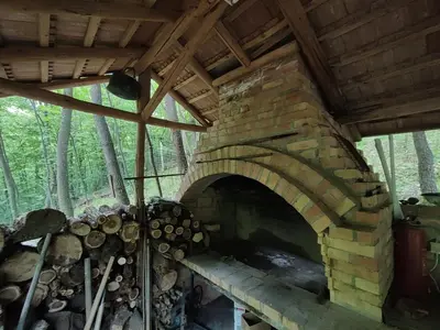 a large brick oven in the woods at Kuca za odmor Lisine in Despotovac