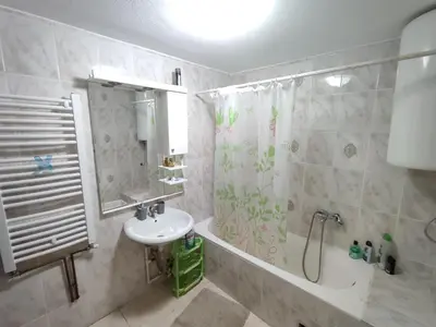 a bathroom with a sink and a shower and a tub at Kuca za odmor Lisine in Despotovac