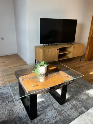 a living room with a coffee table and a flat screen tv at LiboroApartments in Niš