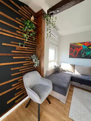 a living room with a couch and a chair at LiboroApartments in Niš