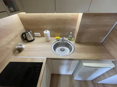 a counter with a sink in a small kitchen at Apartmani Videnovic Sokobanja in Soko Banja