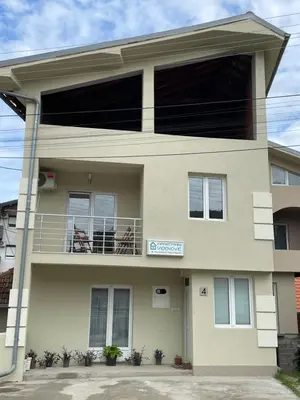 a house with a balcony on top of it at Apartmani Videnovic Sokobanja in Soko Banja