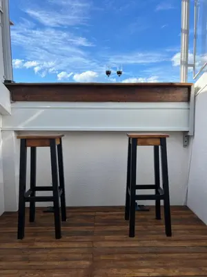 a counter with two stools in front of a window at LiboroApartments in Niš