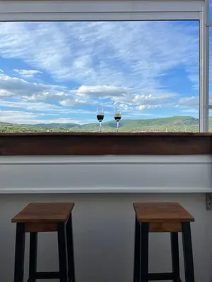two glasses of wine sitting on top of a window at LiboroApartments in Niš