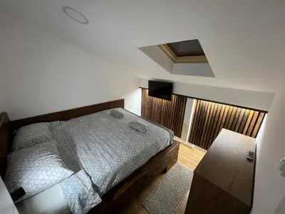 a small bedroom with a bed and a window at LiboroApartments in Niš