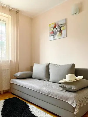 a living room with a couch with a hat on it at Apartment, Vrnjacka-Banja, Raj in Vrnjačka Banja