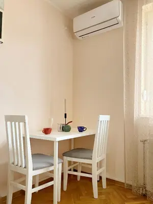 a white table and two chairs in a room at Apartment, Vrnjacka-Banja, Raj in Vrnjačka Banja