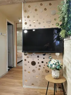 a flat screen tv on a wall in a living room at URBAN Life STYLE in Zaječar
