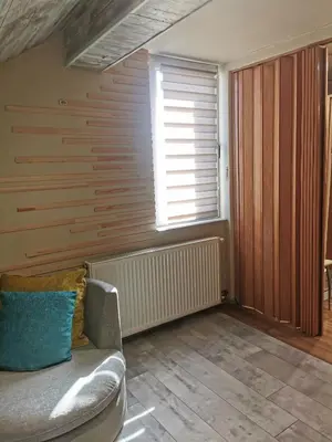 a living room with a couch and a window at URBAN Life STYLE in Zaječar