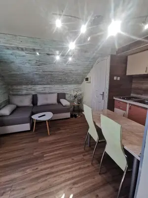 a living room with a couch and a table and chairs at URBAN Life STYLE in Zaječar