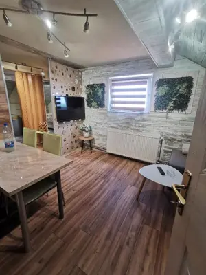 a living room with a table and a television at URBAN Life STYLE in Zaječar