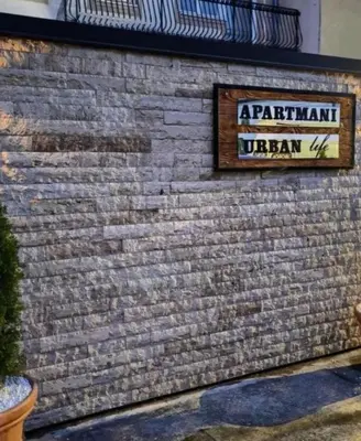 a sign on the side of a brick wall at URBAN Life STYLE in Zaječar