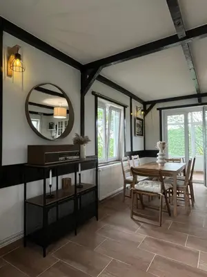 a dining room with a table and a mirror at Villa Buena in Despotovac