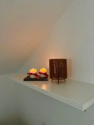 two candles sitting on a shelf in a room at Villa Buena in Despotovac