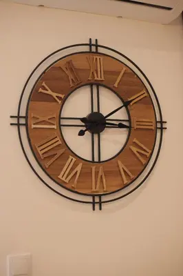 a wooden clock hanging on a wall at Apartman Zivic in Vrnjci