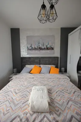 a bedroom with a large bed with orange pillows at Apartman Zivic in Vrnjci