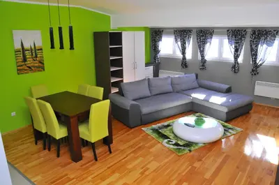 a living room with a couch and a table at APARTMENTS FOKA & SPA - 600m from Gondola ski lift in Kopaonik
