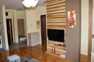 a living room with a wall with a flat screen tv at APARTMENTS FOKA & SPA - 600m from Gondola ski lift in Kopaonik