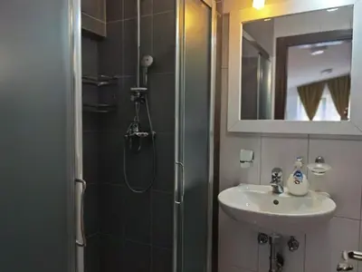 a bathroom with a shower and a sink and a mirror at APARTMENTS FOKA & SPA - 600m from Gondola ski lift in Kopaonik