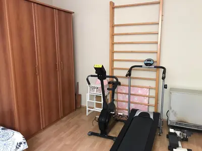 a gym room with a treadmill and a closet at Apartman Spasic in Ribarska Banja