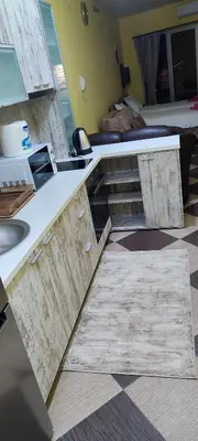 a kitchen with a counter with a sink and a bed at Studio Apartman Ad fines in Kuršumlija