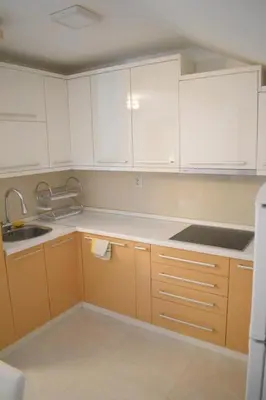 a kitchen with white cabinets and a sink at Apartman Nina in Vranje