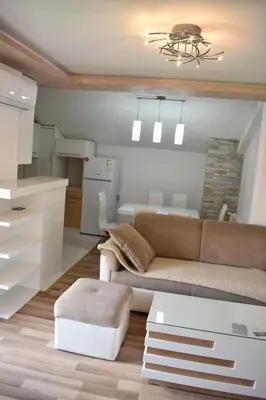 a living room with a couch and a kitchen at Apartman Nina in Vranje