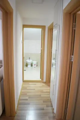 a hallway leading to a bathroom with a sink at Apartman Nina in Vranje