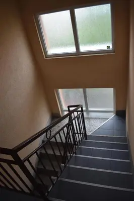 a staircase in a building with a window at Apartman Nina in Vranje