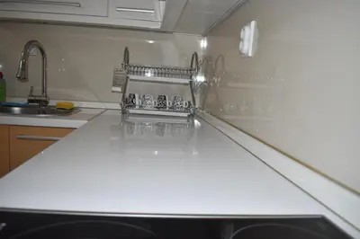 a kitchen with a white counter and a refrigerator at Apartman Nina in Vranje