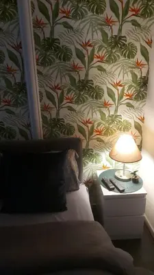 a bedroom with a bed and a table with a lamp at Nena Studio in Jagodina
