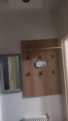 a mirror on a wall next to a bathroom at Nena Studio in Jagodina