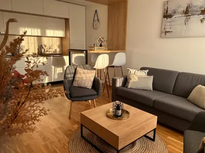 a living room with a couch and a table at Prirodni Raj-Udoban Sokobanja Apartman in Soko Banja